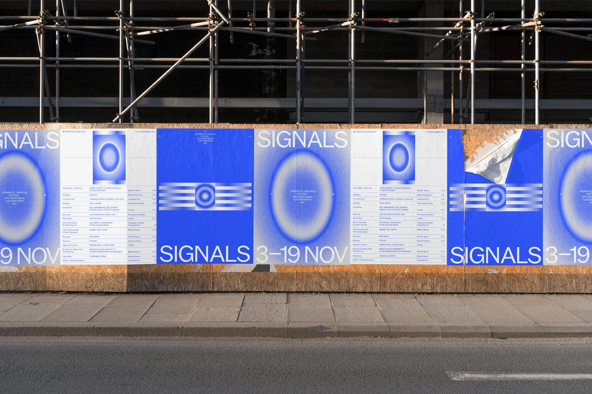 Signals campaign posters with blue light signatures across a city hoarding
