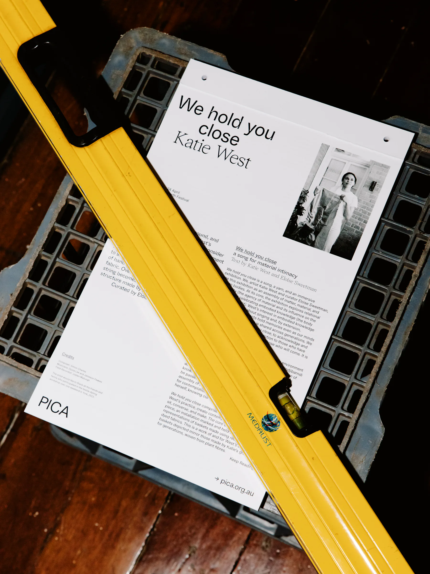 PICA exhibition programme displayed on a ladder during gallery installation