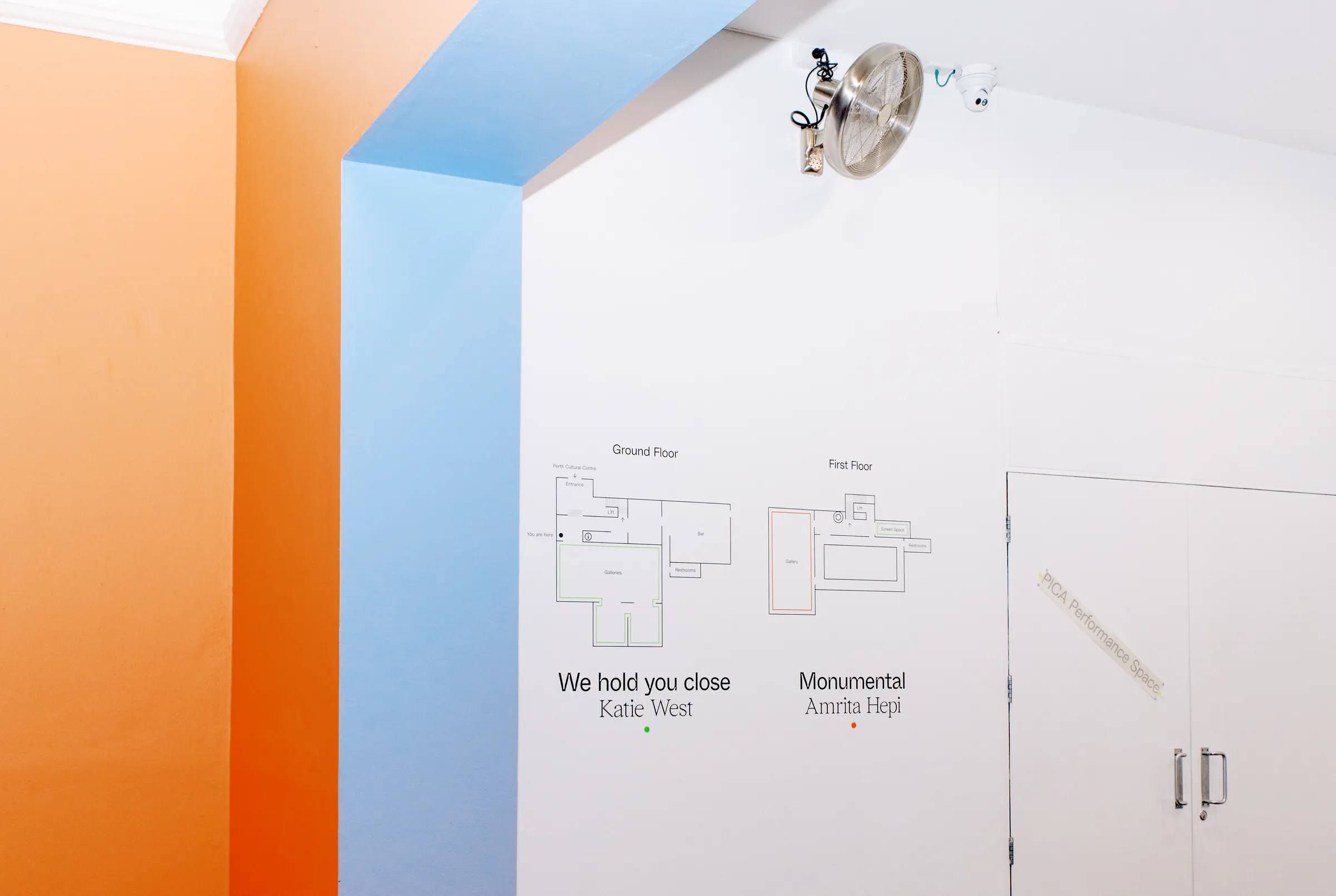 PICA internal wayfinding with exhibition titles, floor plans and coloured architectural bands