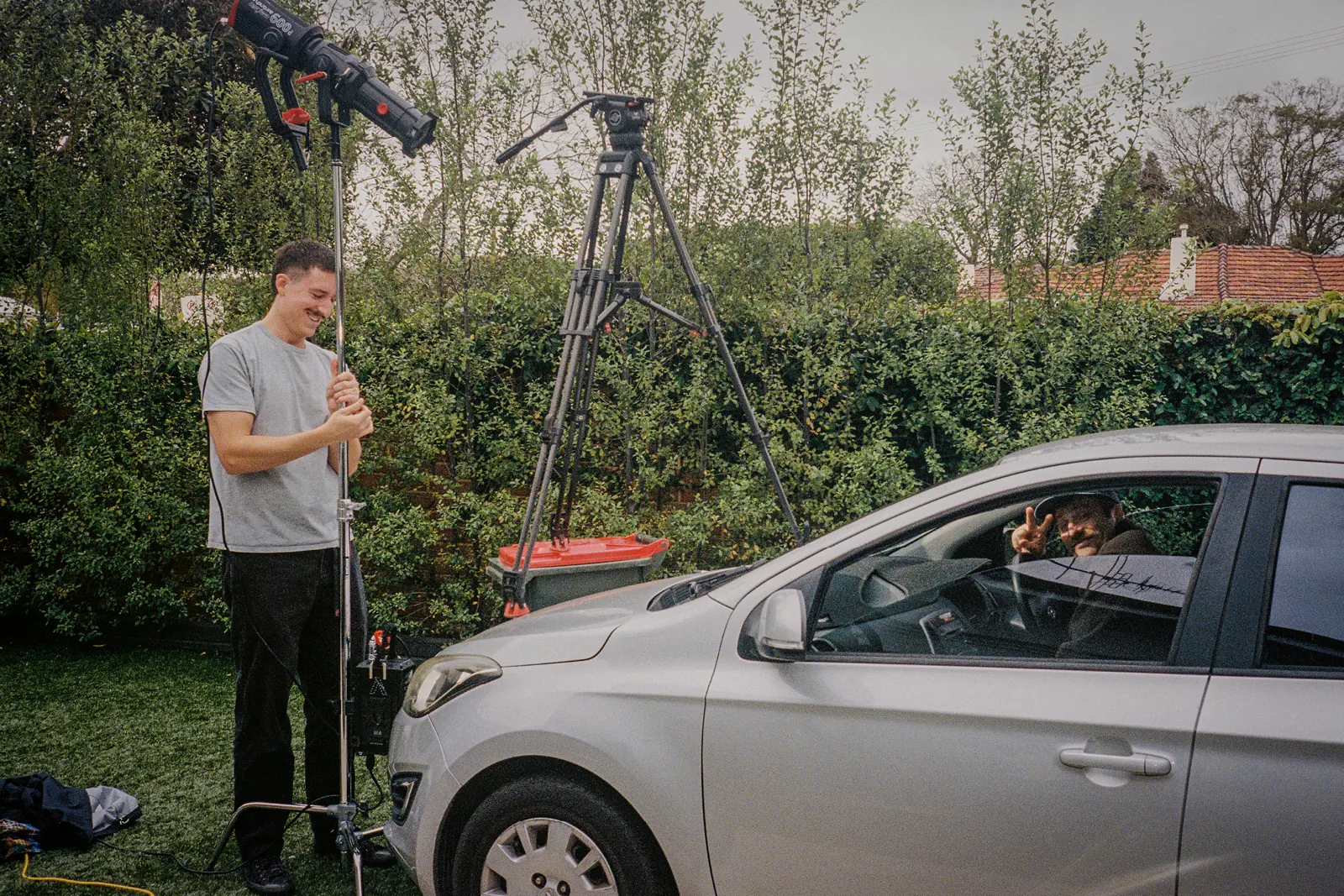 Behind the scenes on the Sports Dreams shoot beside a car and basketball court