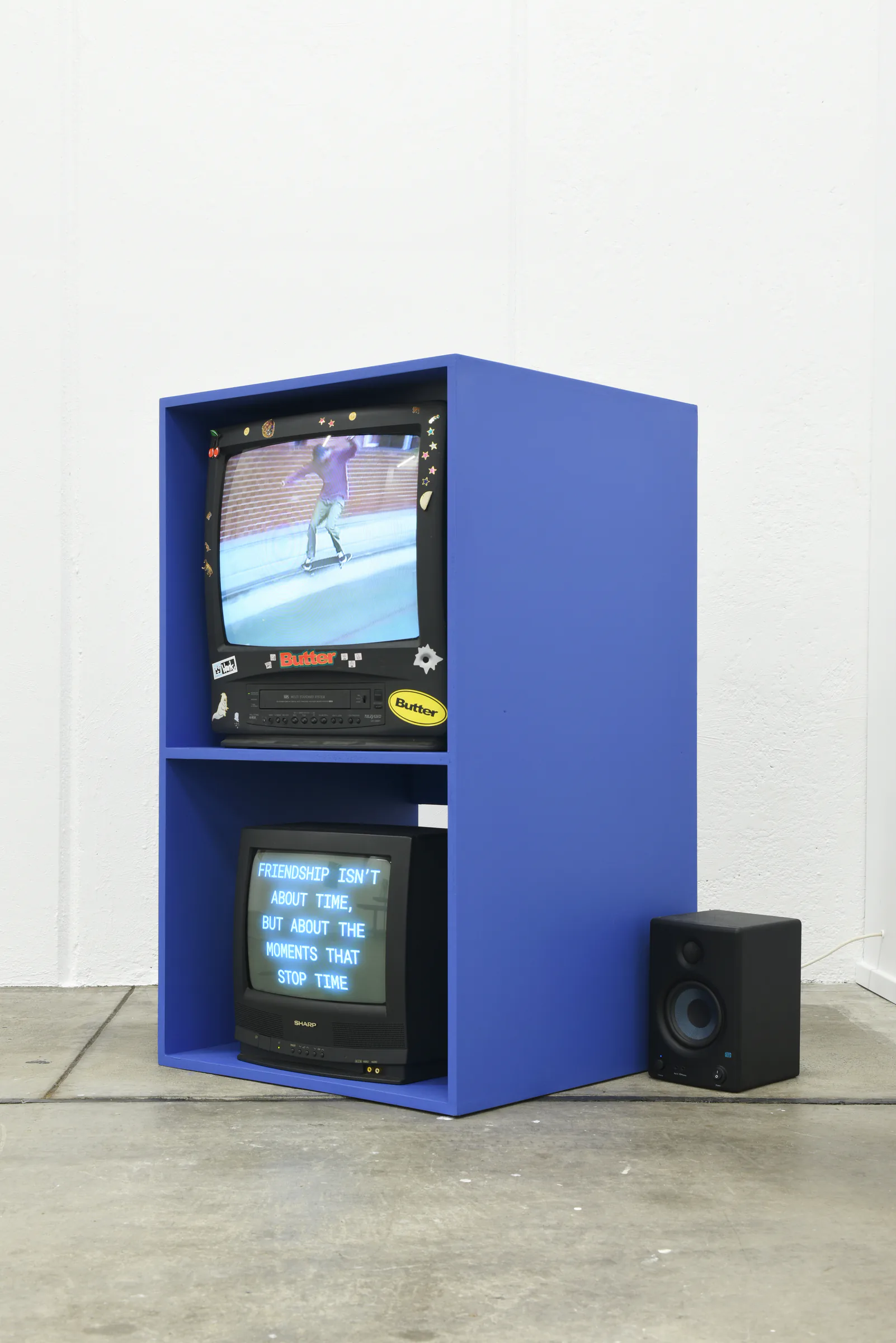 Custom blue video cabinet showing the Sports Dreams moving-image work