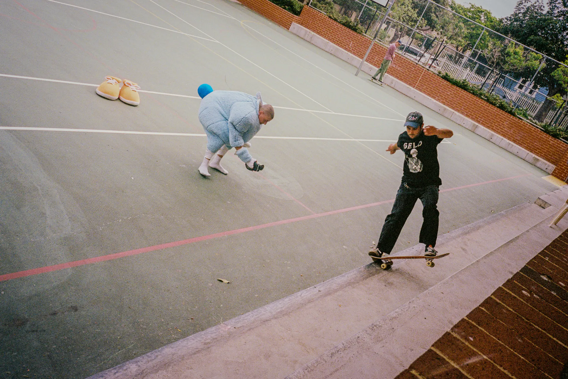 Sports Dreams mascot on a basketball court with a skateboarder