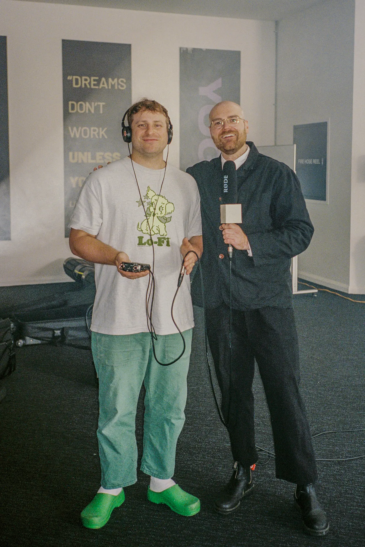 Two Sports Dreams collaborators posing with the mascot costume in the studio